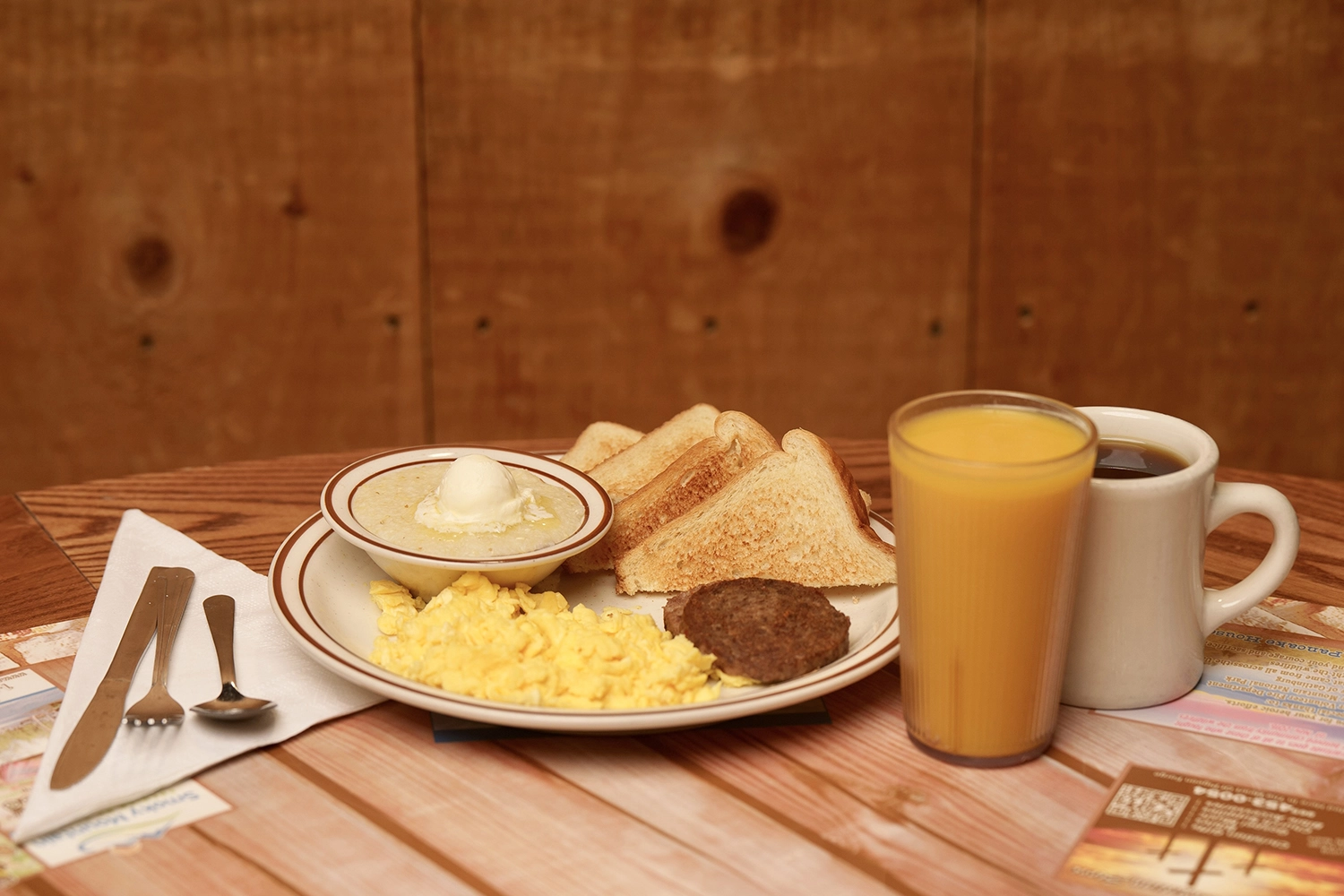 coffee and orange juice served with a breakfast plate