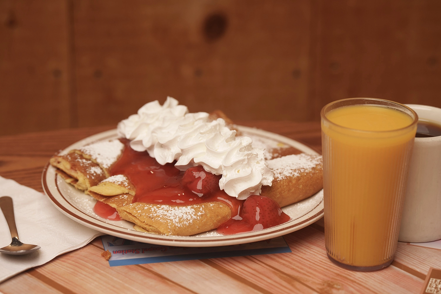 strawberry crepes with a glass of orange juice